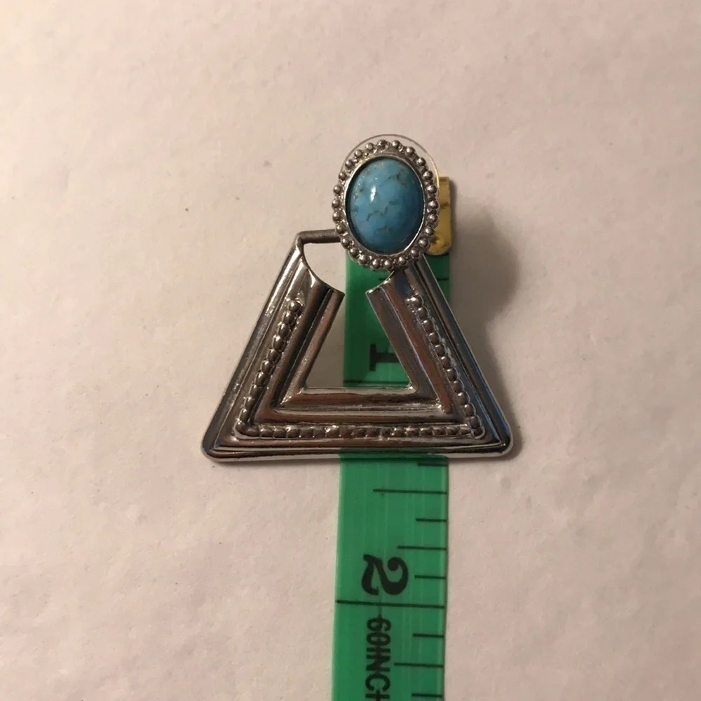 Silver triangular shaped earrings turquoise colored stone at peak that swivels
